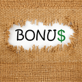Text reading “BONUS” with the dollar sign styled in green, revealed through a torn opening in a burlap or woven fabric background.